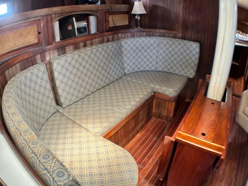 Slide: The Image of Interior of 1982 Pan Oceanic 43 sailboat with cushioned seating and wooden paneling. - 15