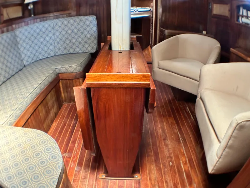 Slide: The Image of Interior of 1982 Pan Oceanic 43 sailboat with wooden flooring and cozy seating. - 16