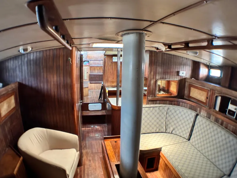 Slide: The Image of Interior of 1982 Pan Oceanic 43 sailboat with wooden paneling and cozy seating area. - 18