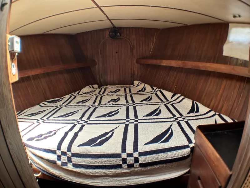 Slide: The Image of Cozy cabin interior of 1982 Pan Oceanic 43 sailboat with patterned bedding. - 24