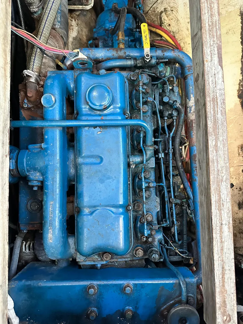 Slide: The Image of Engine of a 1982 Pan Oceanic 43 boat, featuring blue components and visible wiring. - 29