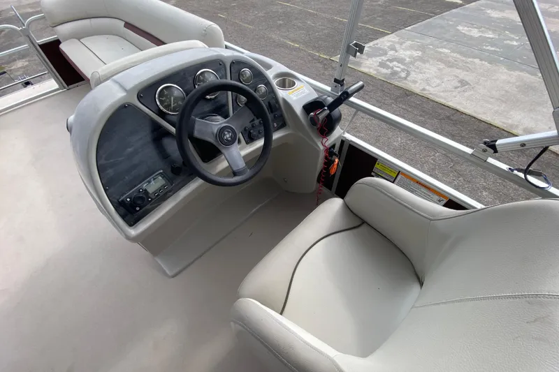 Slide: The Image of 2020 Godfrey 180 SR boat interior with steering wheel and seating area. - 10