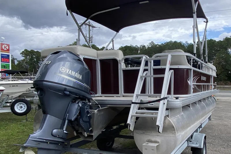 Slide: The Image of 2020 Godfrey 180 SR pontoon boat with Yamaha outboard motor, parked outdoors. - 2
