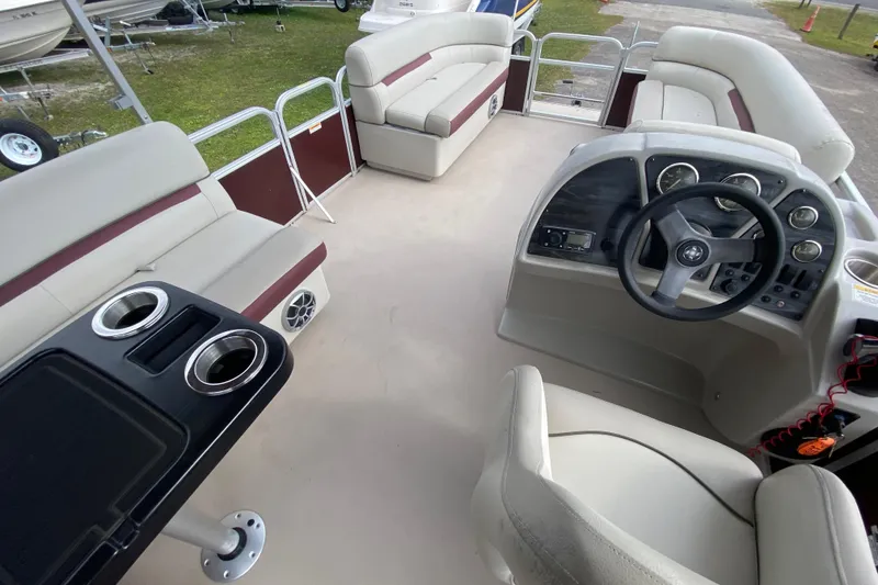 Slide: The Image of Interior of a 2020 Godfrey 180 SR pontoon boat with seating and steering console. - 9