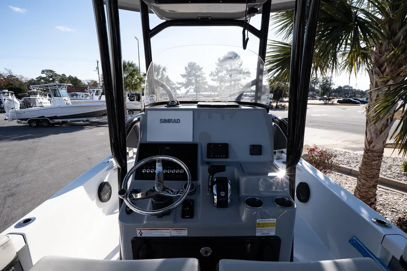 Slide: The Image of 2026 Sea Pro 250 Bay boat dashboard with steering wheel and Simrad electronics. - 11