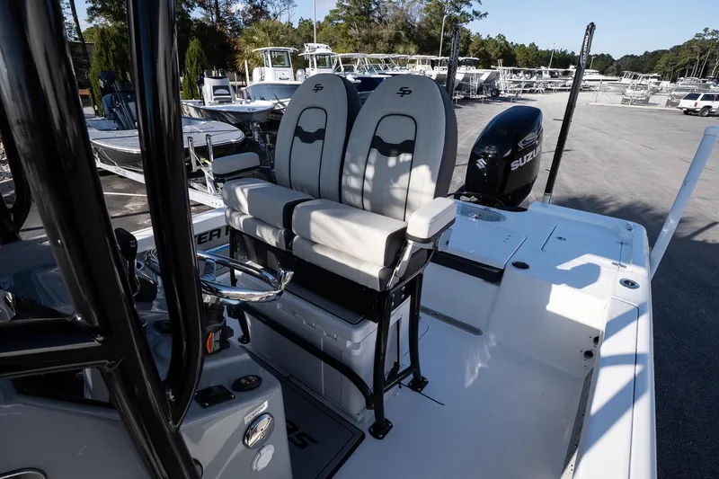 Slide: The Image of 2026 Sea Pro 250 Bay boat interior with dual seats and Suzuki outboard motor. - 14