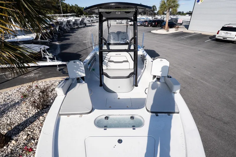 Slide: The Image of 2026 Sea Pro 250 Bay boat with seating and console, parked in a dealership lot. - 18