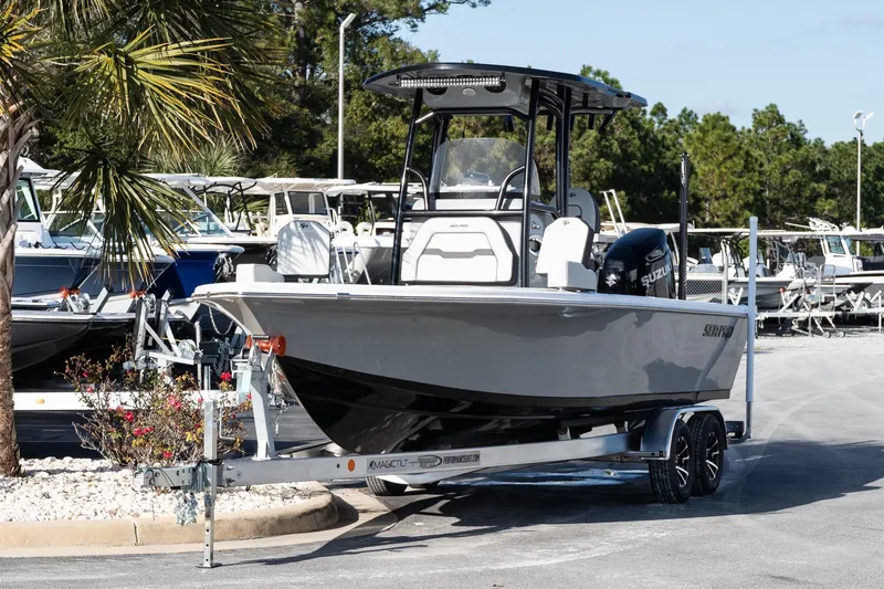 Slide: The Image of 2026 Sea Pro 250 Bay boat on trailer, parked outdoors near palm tree. - 3