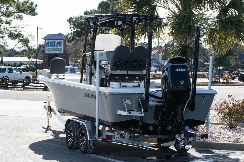 Slide: The Image of 2026 Sea Pro 250 Bay boat on trailer, parked near Neuse Sport Shop. - 5