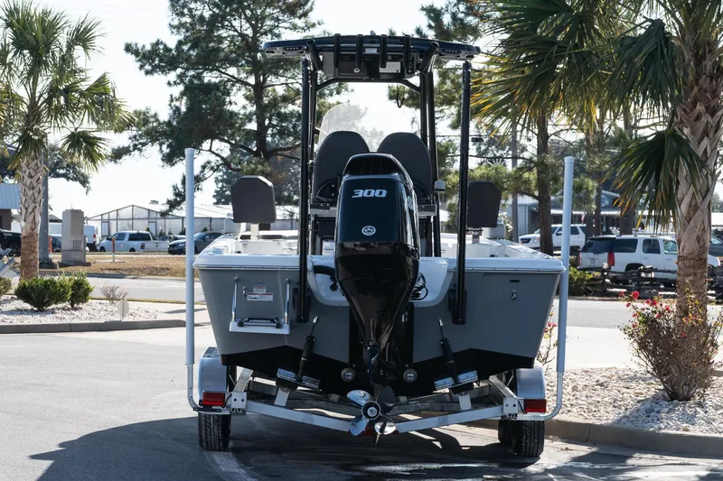 Slide: The Image of 2026 Sea Pro 250 Bay boat on trailer, parked near palm trees. - 6