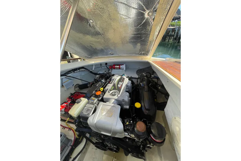 Slide: The Image of 2018 Chris-Craft Capri 27 engine compartment with visible components and wiring. - 18