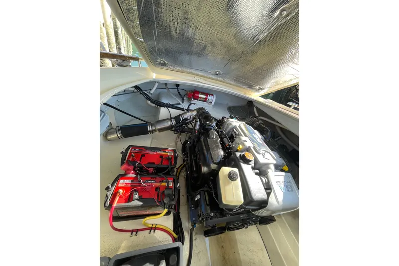Slide: The Image of Engine compartment of 2018 Chris-Craft Capri 27 boat with visible components. - 19