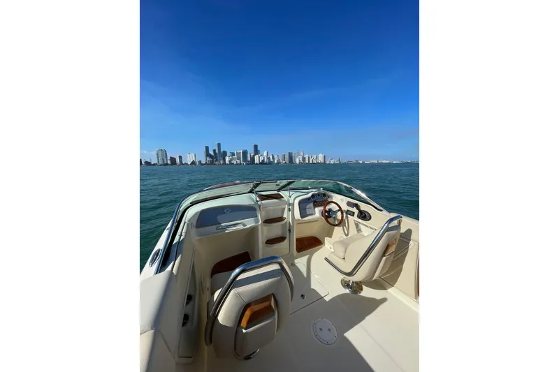 Slide: The Image of 2018 Chris-Craft Capri 27 boat interior with city skyline view. - 2