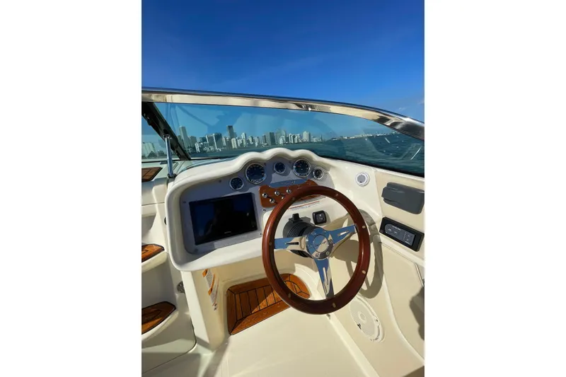 Slide: The Image of 2018 Chris-Craft Capri 27 dashboard with city skyline view. - 7