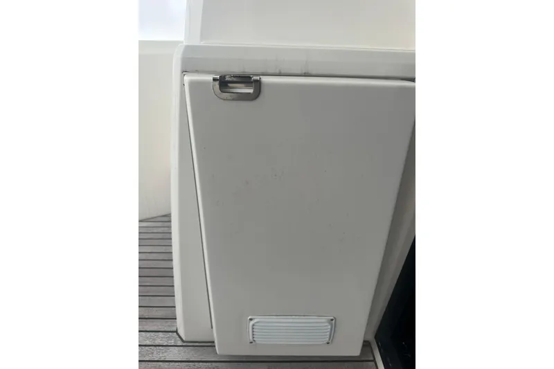 Slide: The Image of White panel on a 2020 Prestige 460 yacht with a metal handle and vent. - 11