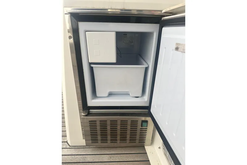 Slide: The Image of Open freezer compartment on a 2020 Prestige 460 yacht, showcasing interior storage space. - 12