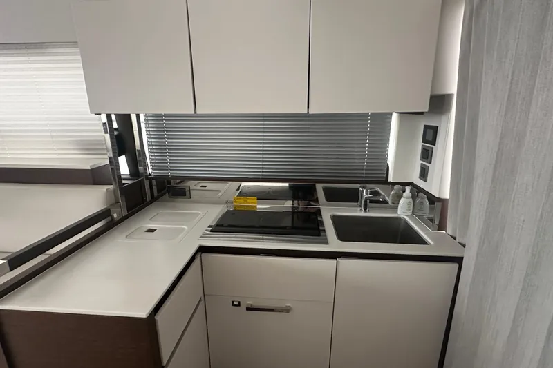 Slide: The Image of Modern kitchen in a 2020 Prestige 460 yacht with sleek cabinetry and appliances. - 15