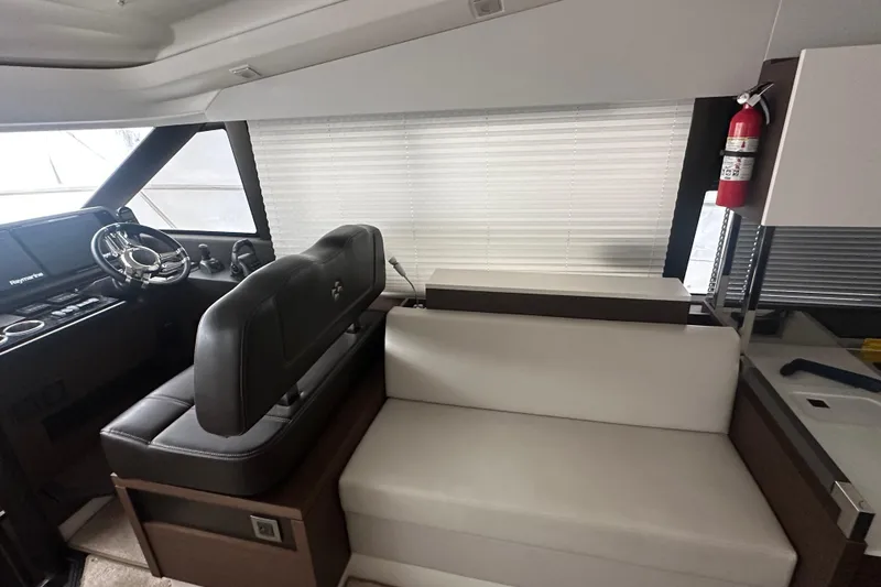 Slide: The Image of Interior of 2020 Prestige 460 yacht with helm, seating, and fire extinguisher. - 25