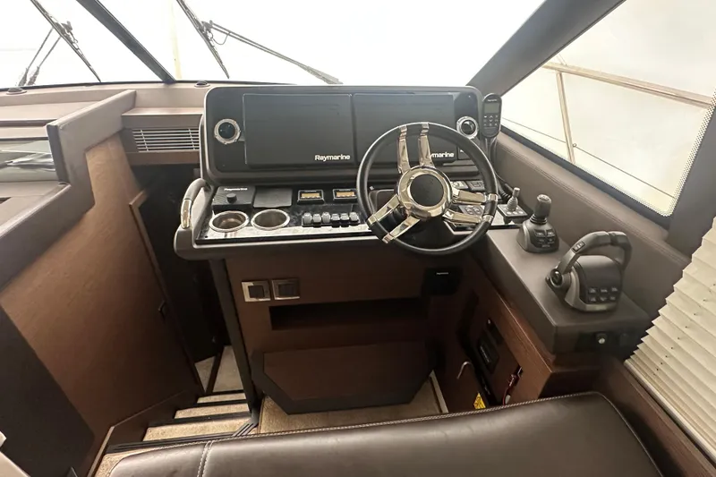 Slide: The Image of Cockpit of 2020 Prestige 460 yacht with Raymarine navigation system and modern controls. - 26