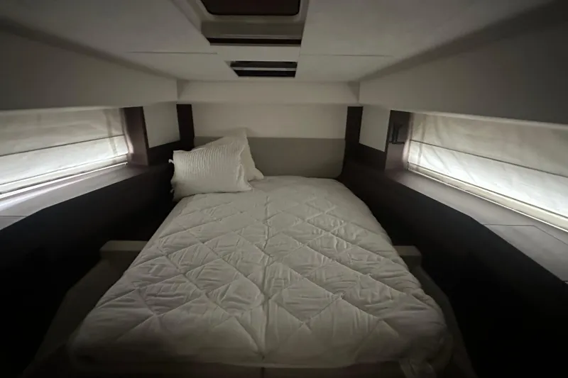 Slide: The Image of Luxurious cabin interior of 2020 Prestige 460 yacht with cozy bed and soft lighting. - 31