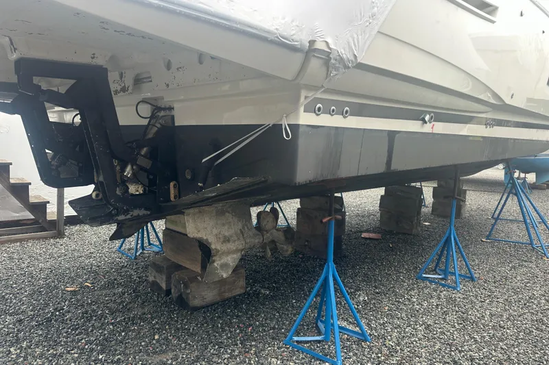 Slide: The Image of 2020 Prestige 460 yacht on stands for maintenance, showing hull and propeller area. - 46