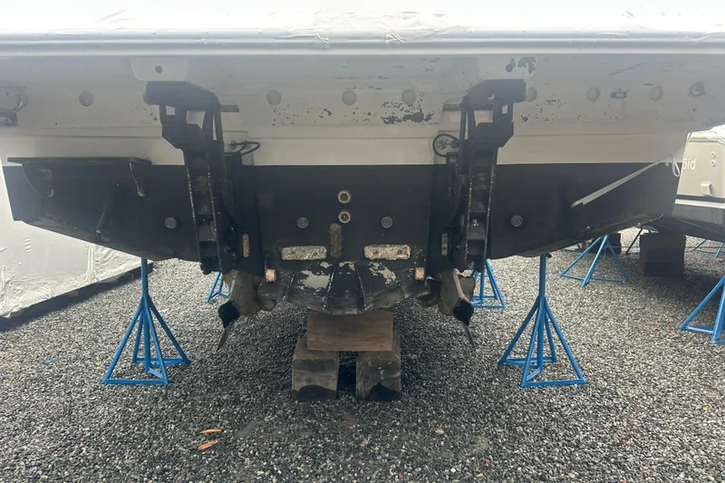 Slide: The Image of Rear view of a 2020 Prestige 460 boat on stands, showing the hull and propeller area. - 49