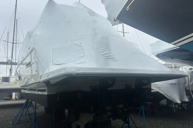 Slide: The Image of Covered 2020 Prestige 460 yacht in storage, supported by stands. - 5