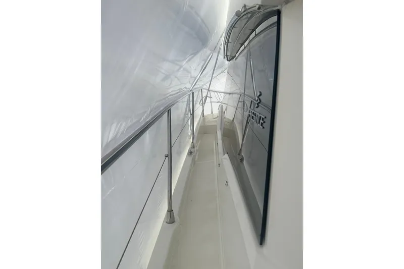 Slide: The Image of Side view of a 2020 Prestige 460 yacht under protective cover. - 50