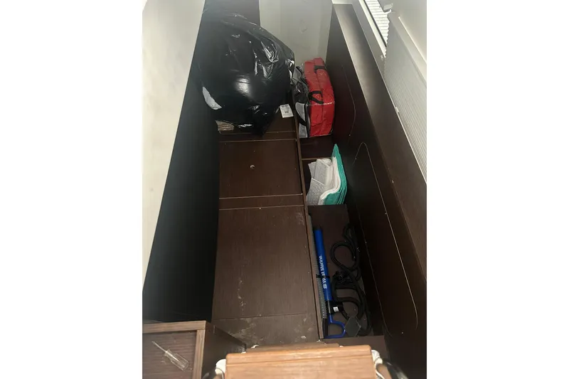 Slide: The Image of Storage compartment in a 2020 Prestige 460 yacht with various items organized neatly. - 54