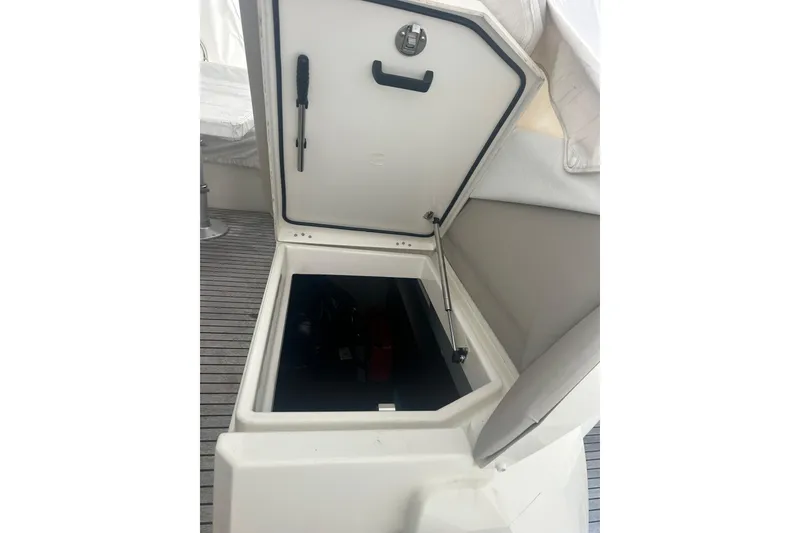 Slide: The Image of Open hatch on 2020 Prestige 460 yacht, revealing storage compartment. - 9