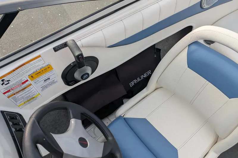 Slide: The Image of 2013 Bayliner 185 Bowrider interior with steering wheel and control panel. - 10