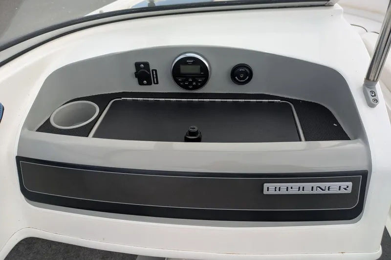 Slide: The Image of 2013 Bayliner 185 Bowrider dashboard with cup holder and control panel. - 12