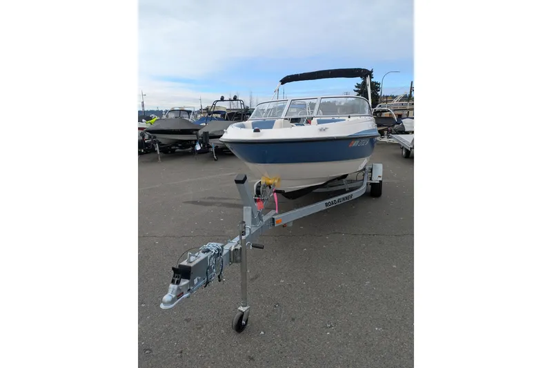 Slide: The Image of 2013 Bayliner 185 Bowrider on trailer, parked in a marina lot. - 5