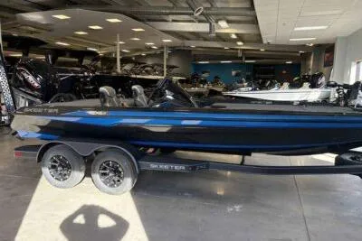 Slide: The Image of 2026 Skeeter ZXE21 boat in showroom, featuring sleek black and blue design. - 2