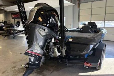 Slide: The Image of 2026 Skeeter ZXE21 boat in showroom, rear view with motor and trailer. - 5