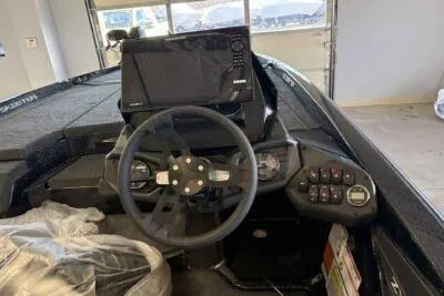 Slide: The Image of 2026 Skeeter ZXE21 boat dashboard with steering wheel and electronic controls. - 6