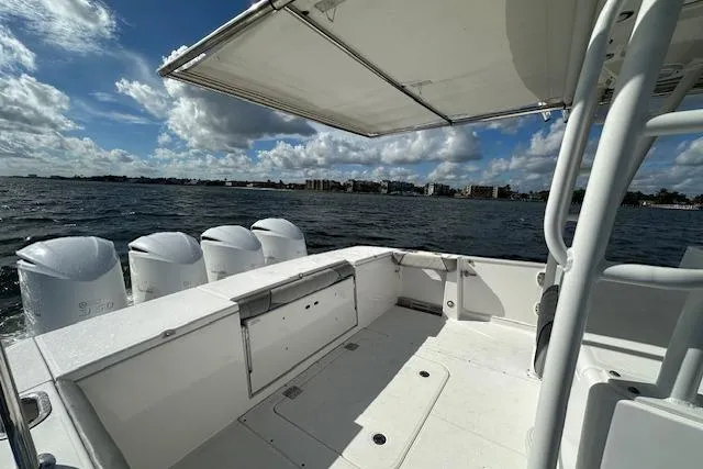 Slide: The Image of 2016 Everglades 435 Center Console boat on water, featuring spacious deck and multiple engines. - 10