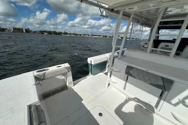 Slide: The Image of 2016 Everglades 435 Center Console boat interior with ocean view and clear skies. - 12
