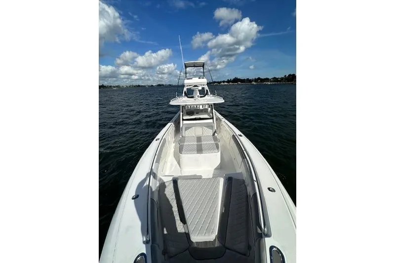 Slide: The Image of 2016 Everglades 435 Center Console boat on open water under blue sky. - 15