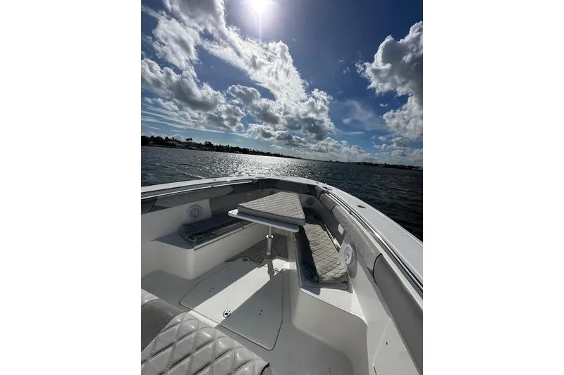 Slide: The Image of 2016 Everglades 435 Center Console boat on water under a sunny sky. - 16