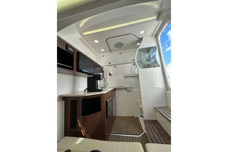 Slide: The Image of Interior of 2016 Everglades 435 Center Console boat with modern amenities and sleek design. - 26