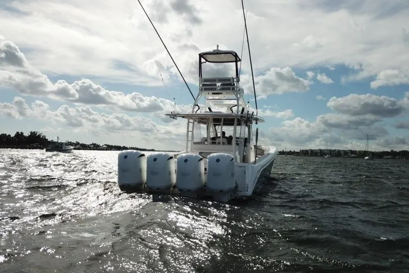 Slide: The Image of 2016 Everglades 435 Center Console boat on choppy water under cloudy sky. - 29
