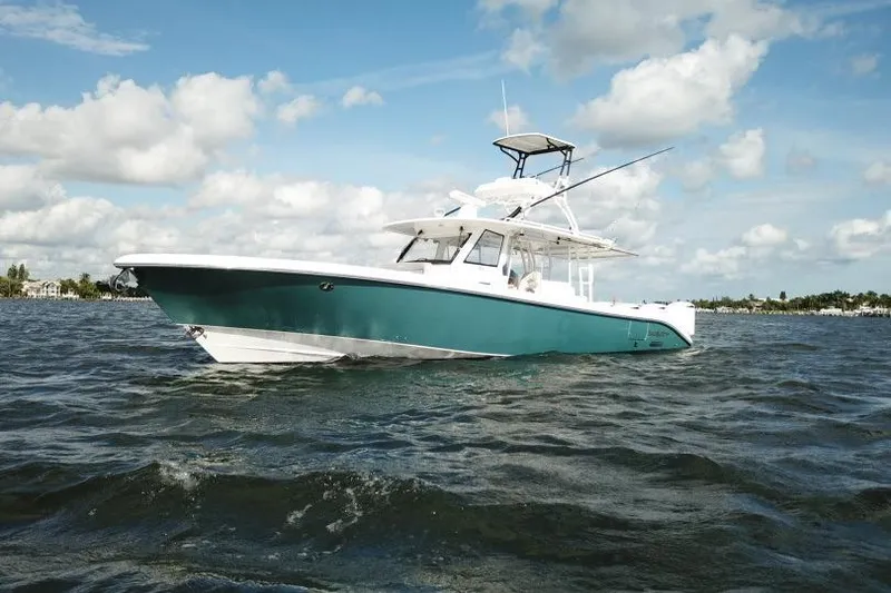Slide: The Image of 2016 Everglades 435 Center Console boat on open water under blue sky. - 4