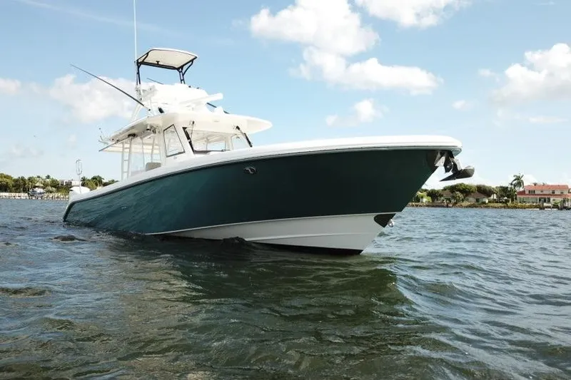 Slide: The Image of 2016 Everglades 435 Center Console boat on water under blue sky. - 5