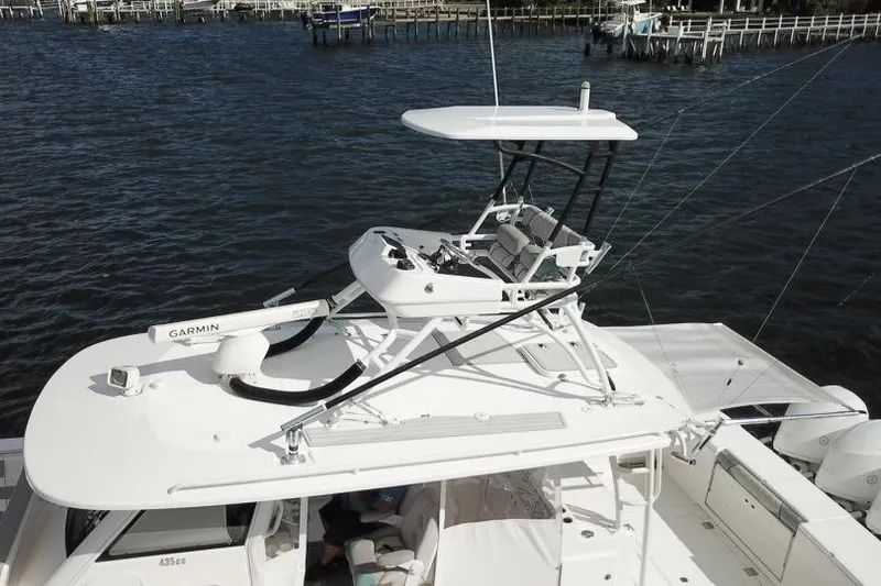 Slide: The Image of 2016 Everglades 435 Center Console boat with upper helm, on water. - 6