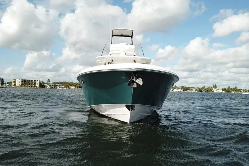 Slide: The Image of 2016 Everglades 435 Center Console boat on water, under a partly cloudy sky. - 7