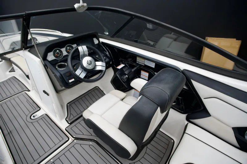 Slide: The Image of 2018 Yamaha Boats 212X interior with steering wheel and seating, showcasing modern design. - 6