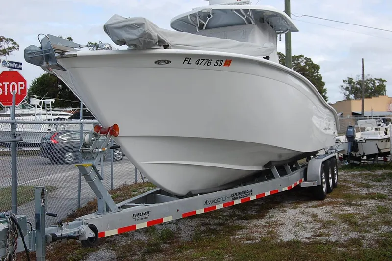 Slide: The Image of 2020 Cape Horn 31T boat on trailer near stop sign and fence. - 21