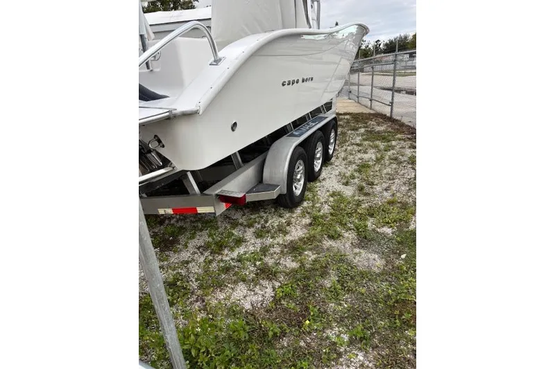 Slide: The Image of 2020 Cape Horn 31T boat on a triple-axle trailer, parked on grass. - 23