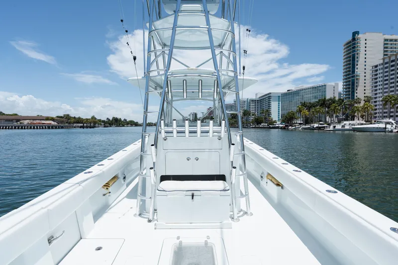 Slide: The Image of 2017 SeaVee 390Z boat on water, city skyline in background, clear blue sky. - 19